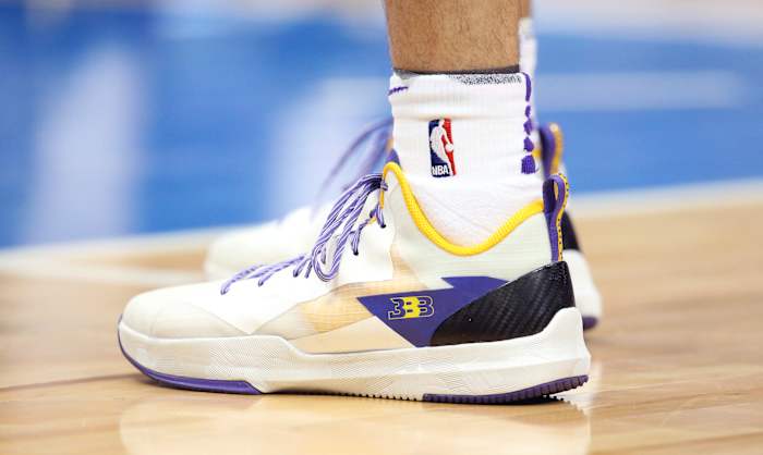 Lonzo Ball's white, purple, and gold basketball shoes.